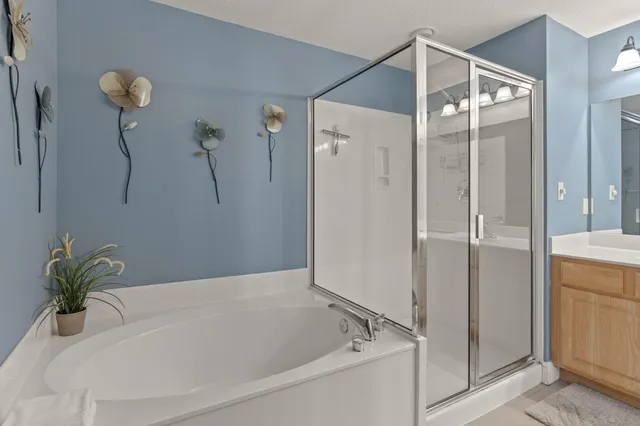 a kitchen with a stove a sink dishwasher a dining table and chairs with wooden floor