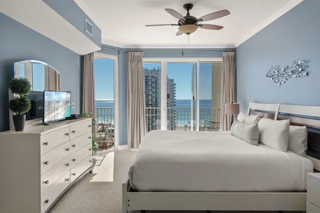 a bedroom with a large bed and a chandelier