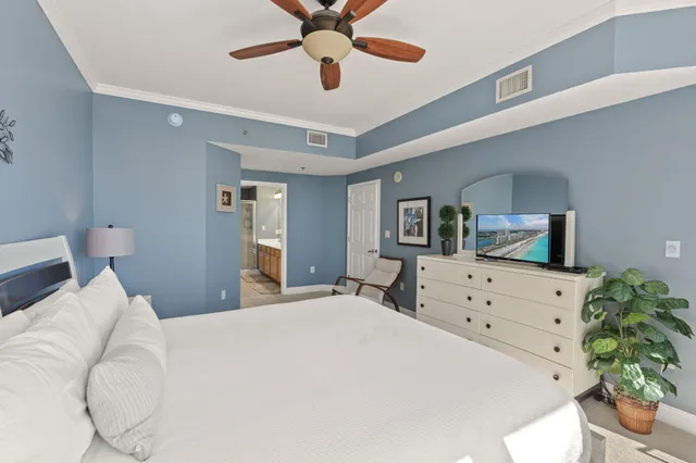 a bedroom with a bed and a chandelier