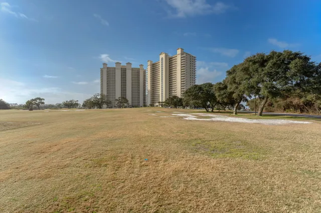 a front view of a residential apartment building with a yard