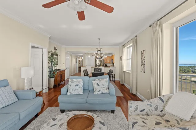 a living room with furniture and a chandelier