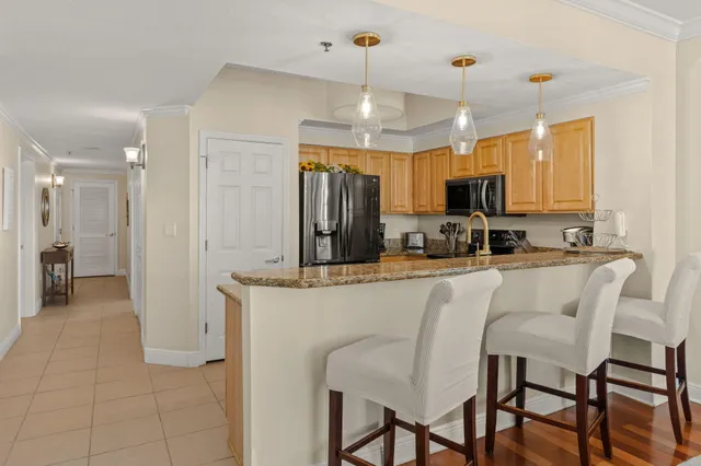 a kitchen with stainless steel appliances a refrigerator sink and microwave