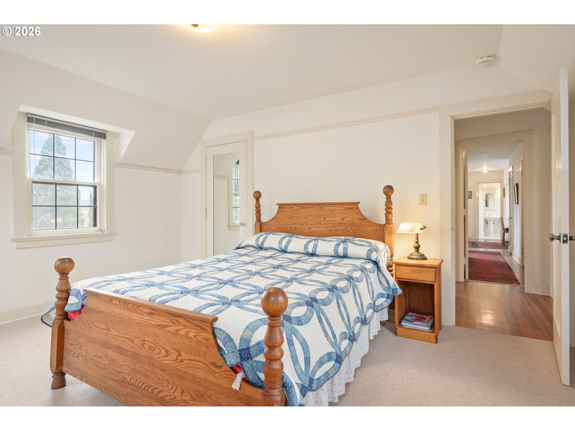 2223 Olive Street Eugene, OR 97405 - Photo 19 of 44 a bedroom with a bed and wooden floor