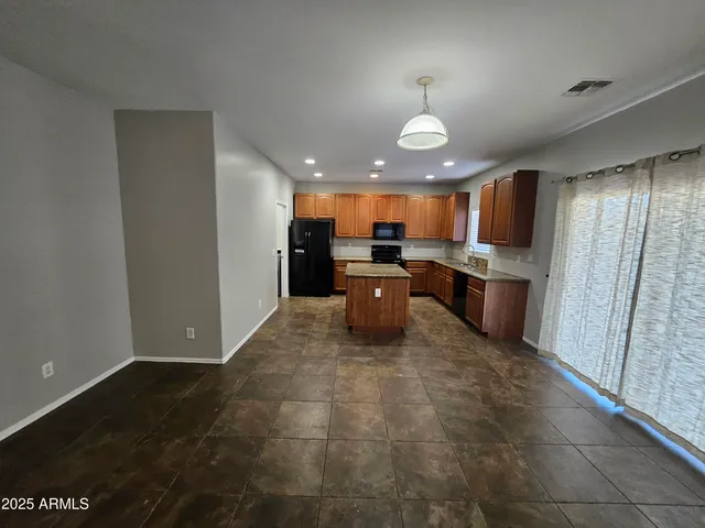 a view of kitchen with refrigerator stove microwave and cabinets