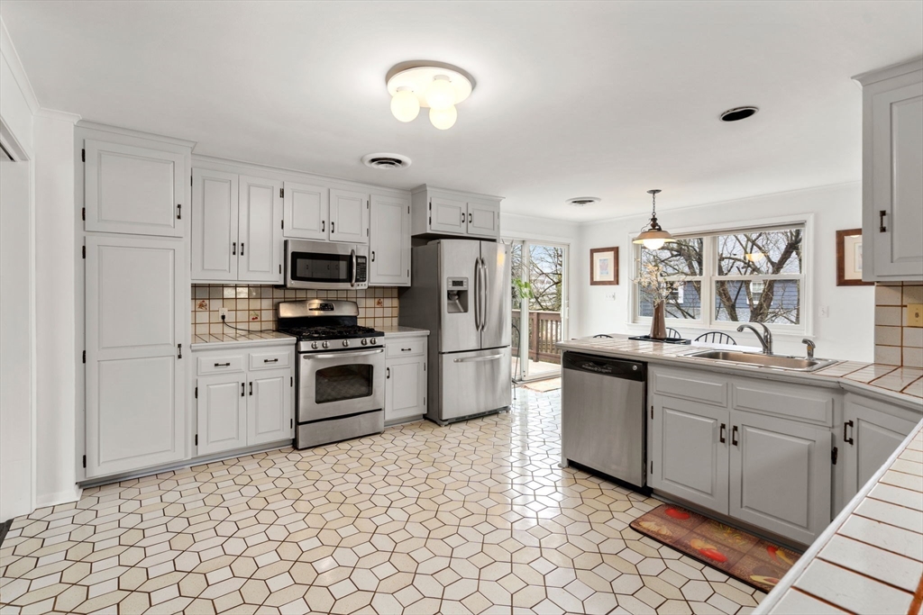 1640 Commonwealth Avenue Newton, MA 02465 - Photo 11 of 27 a kitchen with granite countertop a sink stove and refrigerator