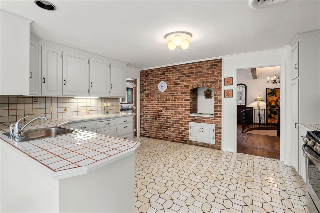 1640 Commonwealth Avenue Newton, MA 02465 - Photo 12 of 27 a kitchen with stainless steel appliances granite countertop a refrigerator and a stove
