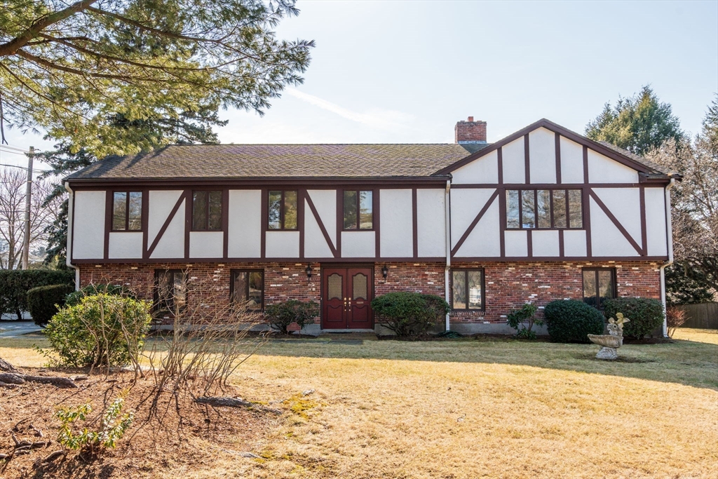 1640 Commonwealth Avenue Newton, MA 02465 - Photo 2 of 27 a front view of a house with a yard and potted plants