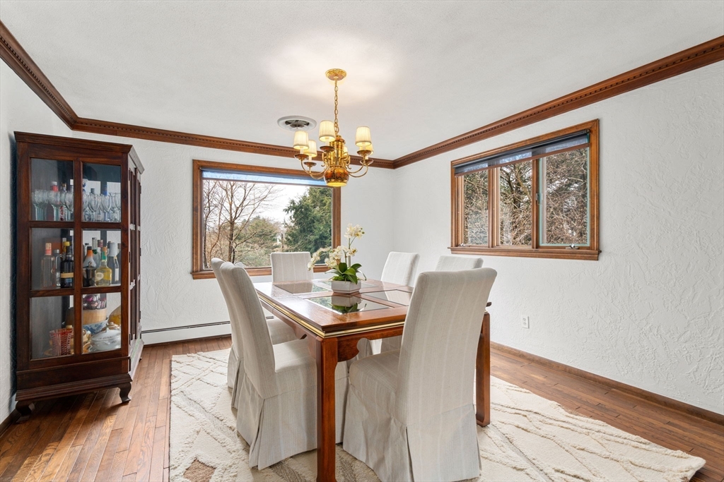 1640 Commonwealth Avenue Newton, MA 02465 - Photo 8 of 27 a dining room with furniture a chandelier and wooden floor