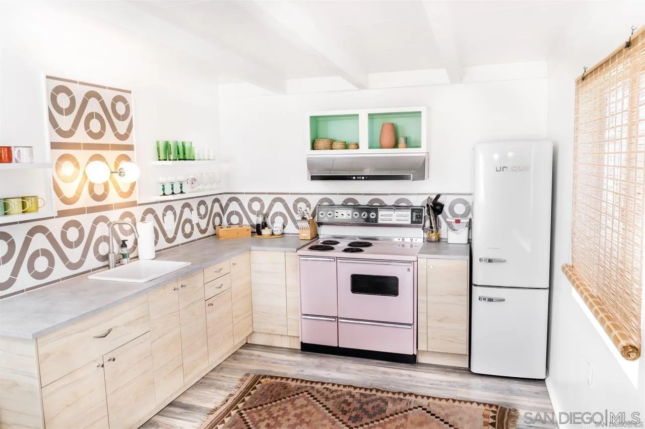 1195 Canyon Road Twentynine Palms, CA 92277 - Photo 5 of 26 a kitchen with white cabinets and white appliances