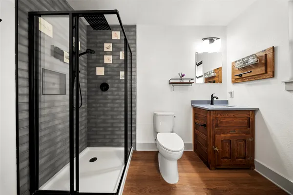 a bathroom with a sink a toilet and shower