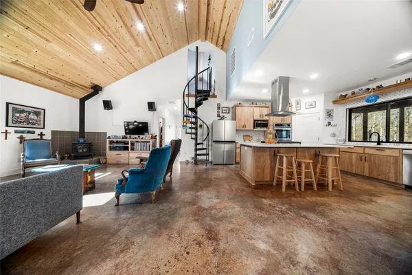 a living room with lots of furniture and kitchen view