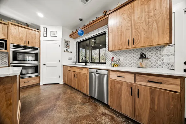 a kitchen with stainless steel appliances granite countertop a stove and a sink