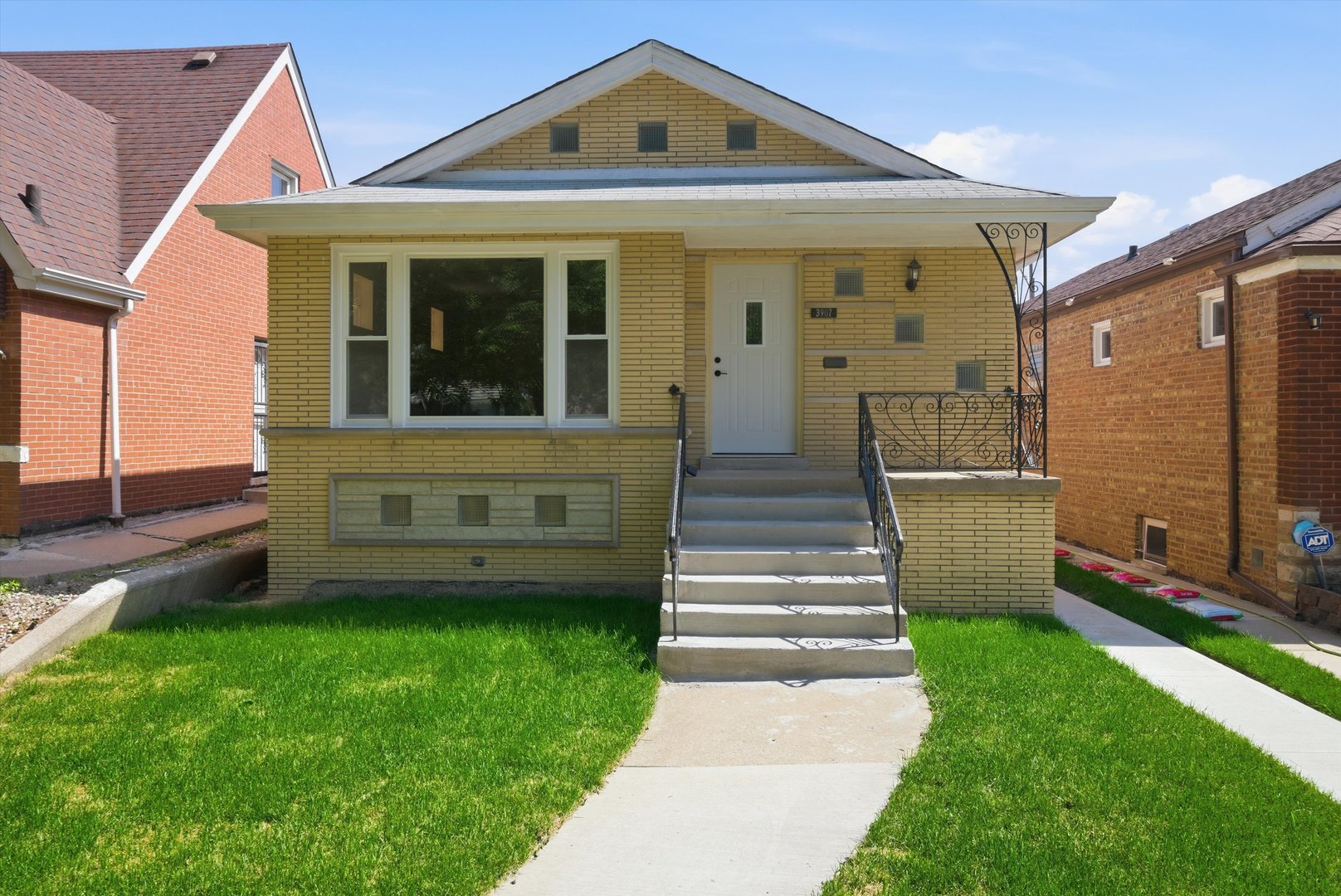 3907 West Marquette Road Chicago, IL 60629 - Photo 2 of 32 a front view of a house with a yard