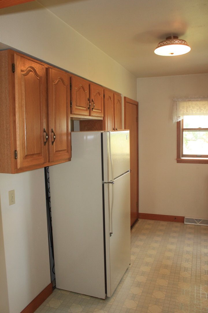 18918 Fairhaven Road Chadwick, IL 61014 - Photo 3 of 18 a view of a refrigerator in kitchen and white cabinets