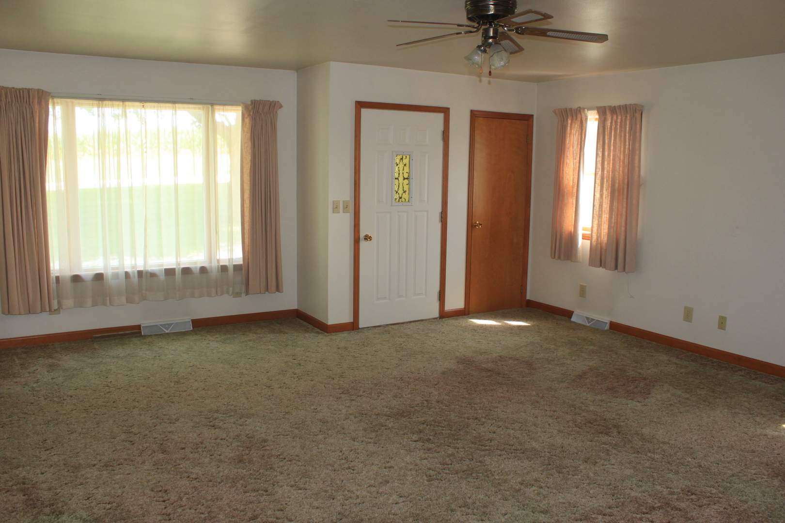 18918 Fairhaven Road Chadwick, IL 61014 - Photo 5 of 18 an empty room with a window and a ceiling fan