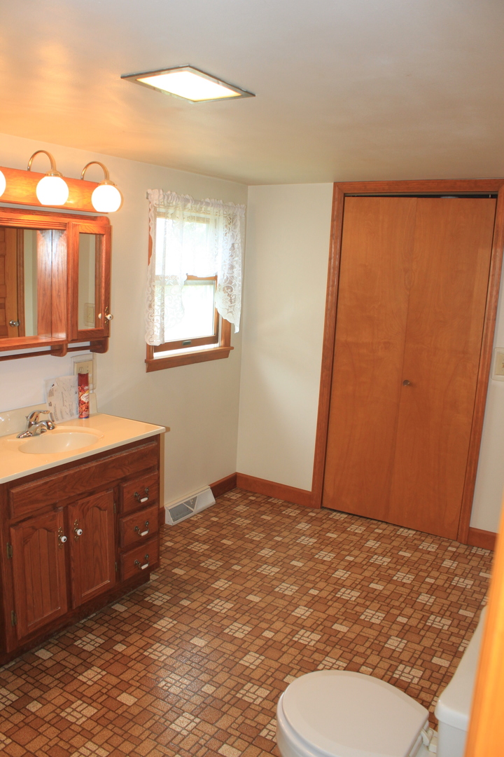 18918 Fairhaven Road Chadwick, IL 61014 - Photo 8 of 18 a bathroom with a sink a toilet and mirror