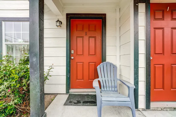 an aerial view of a house with swimming pool and large trees