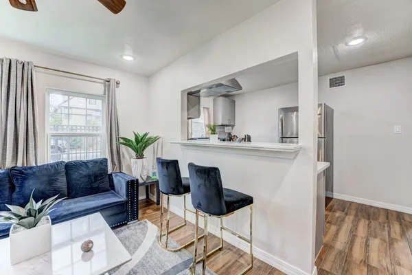a living room with furniture and a potted plant
