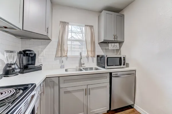 a kitchen with a sink and a microwave