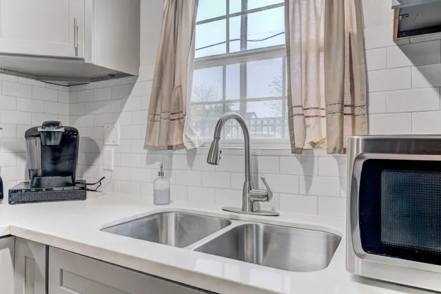 a stove top oven sitting inside of a kitchen