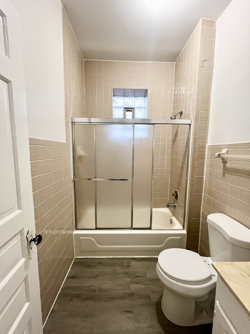 2706 South St Louis Avenue, Unit 3F Chicago, IL 60623 - Photo 7 of 9 a bathroom with a toilet and a shower