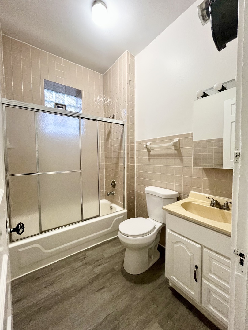 2706 South St Louis Avenue, Unit 3F Chicago, IL 60623 - Photo 8 of 9 a bathroom with a sink toilet and shower