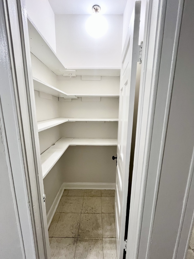 2706 South St Louis Avenue, Unit 3F Chicago, IL 60623 - Photo 9 of 9 a room with a closet and wooden floor