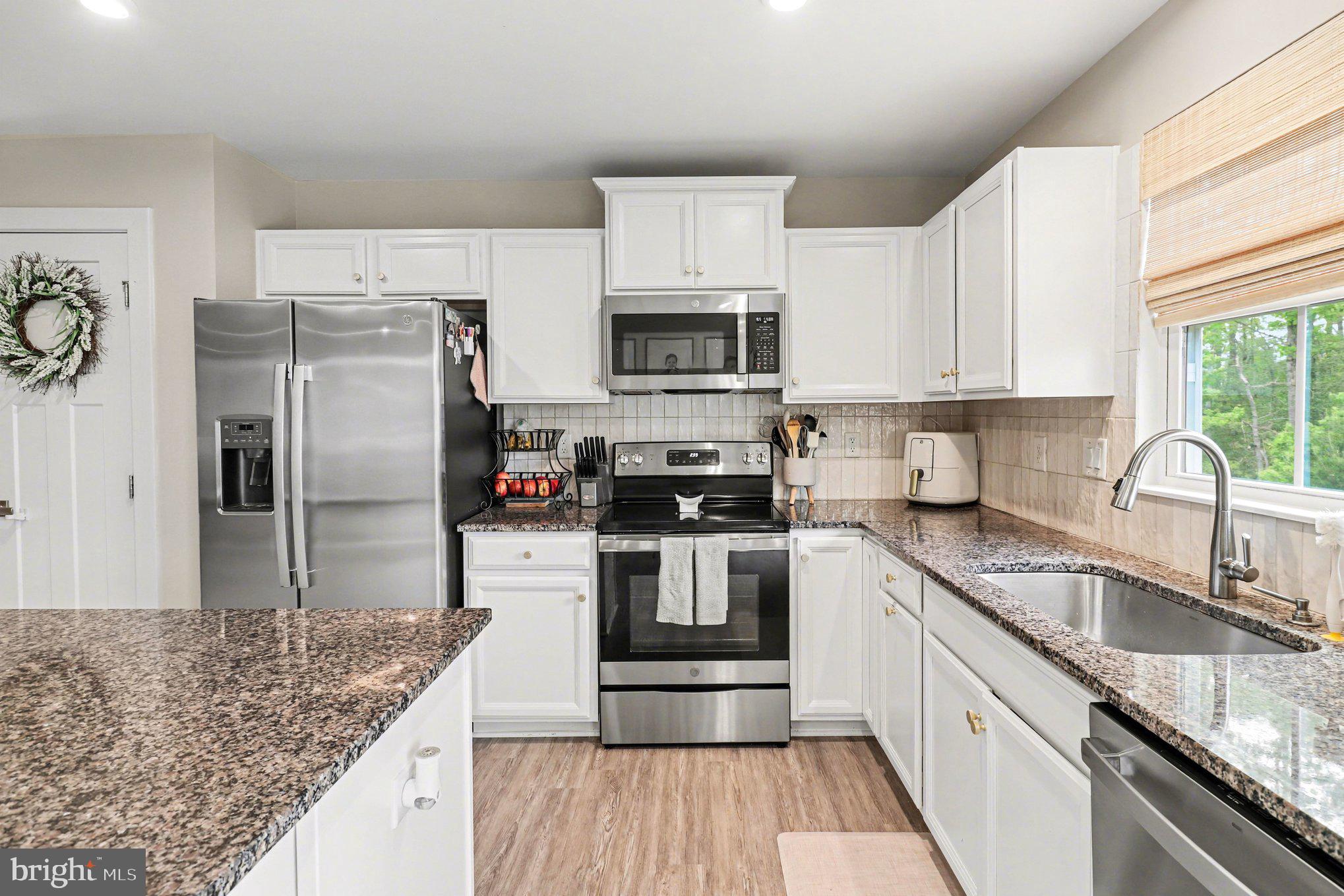 7202 Parchment Circle Ruther Glen, VA 22546 - Photo 8 of 30 a kitchen with granite countertop a refrigerator stove and sink
