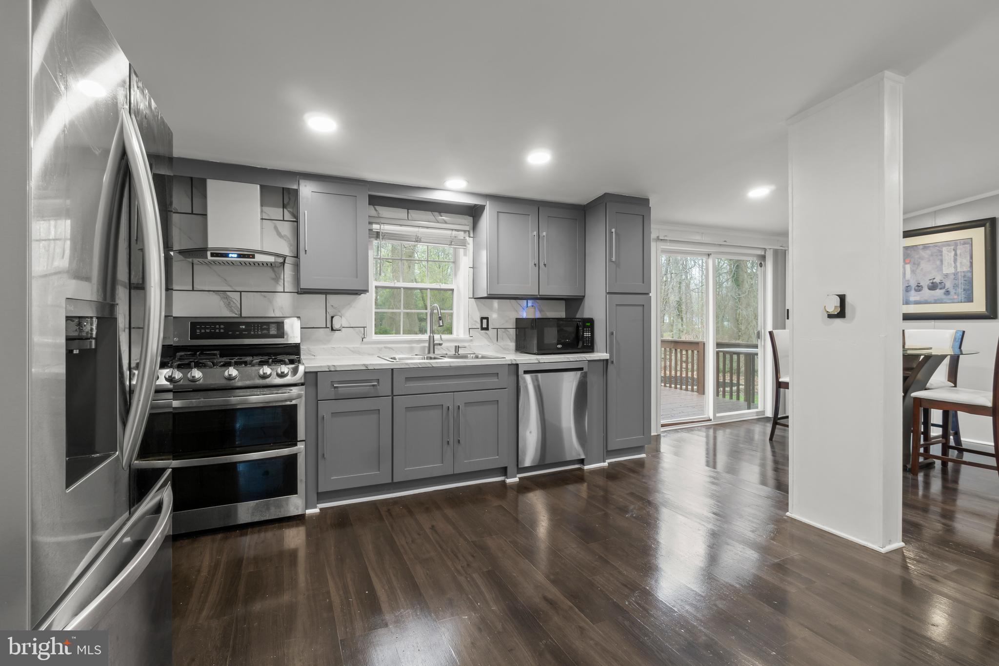 151 Robin Drive West Deptford, NJ 08066 - Photo 7 of 17 a kitchen with granite countertop a refrigerator and a stove top oven