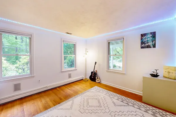 a bed sitting in a bedroom next to a window