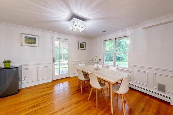 a view of a dining room with furniture window and wooden floor