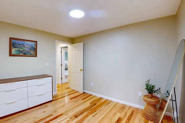 a view of an empty room and wooden floor