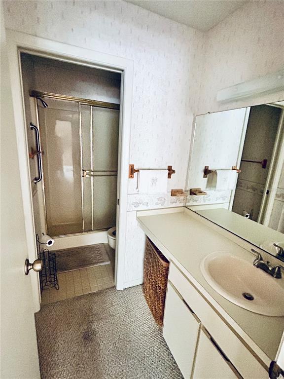 4826 Myrtle Oak Drive, Unit 23 New Port Richey, FL 34653 - Photo 14 of 42 a bathroom with a sink a toilet and a mirror