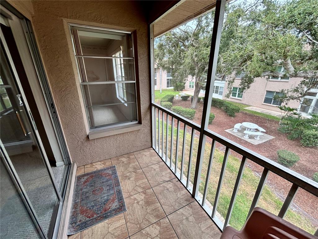 4826 Myrtle Oak Drive, Unit 23 New Port Richey, FL 34653 - Photo 19 of 42 a view of a balcony with wooden floor