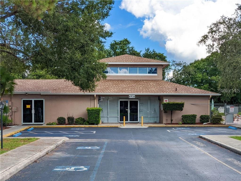 4826 Myrtle Oak Drive, Unit 23 New Port Richey, FL 34653 - Photo 22 of 42 a front view of a house with a garden