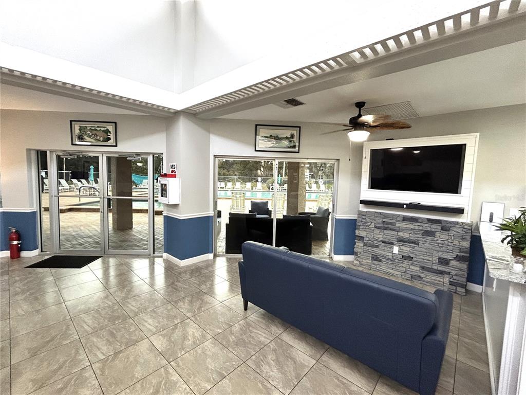 4826 Myrtle Oak Drive, Unit 23 New Port Richey, FL 34653 - Photo 23 of 42 a living room with furniture and a flat screen tv