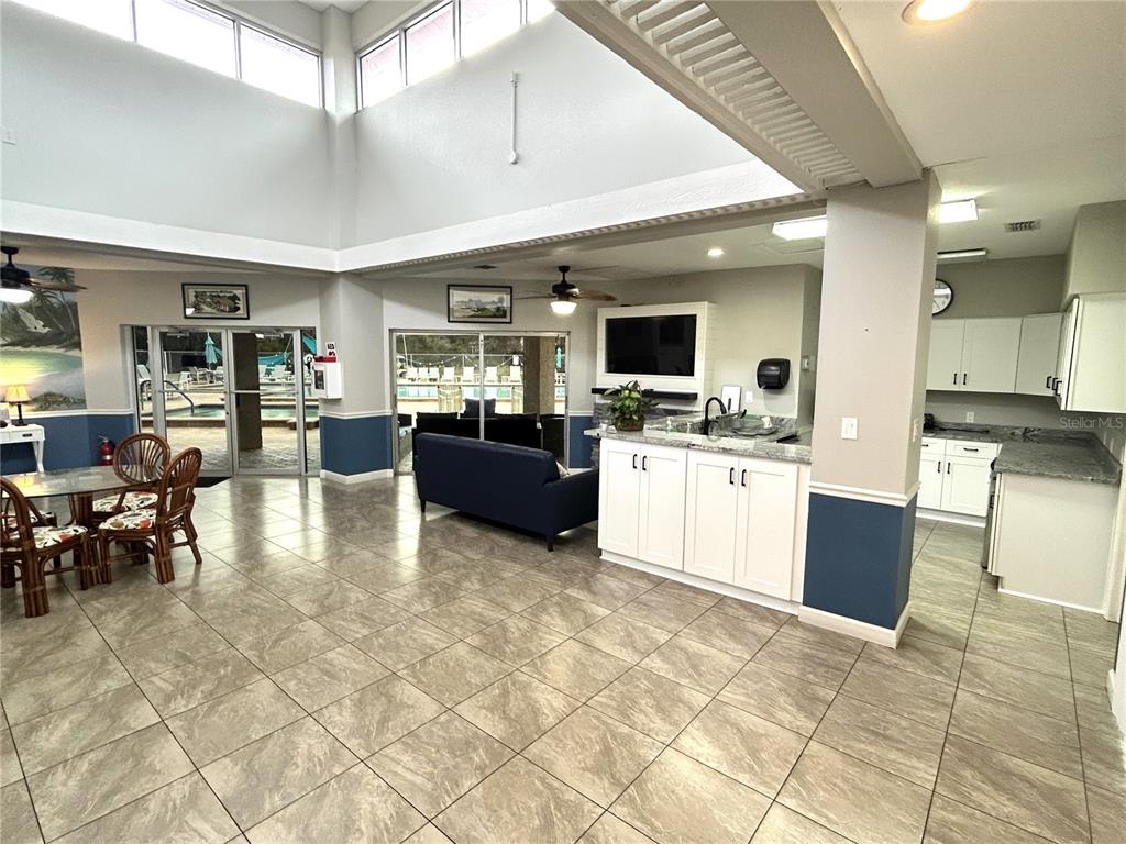 4826 Myrtle Oak Drive, Unit 23 New Port Richey, FL 34653 - Photo 26 of 42 a large white kitchen with lots of counter space and stainless steel appliances