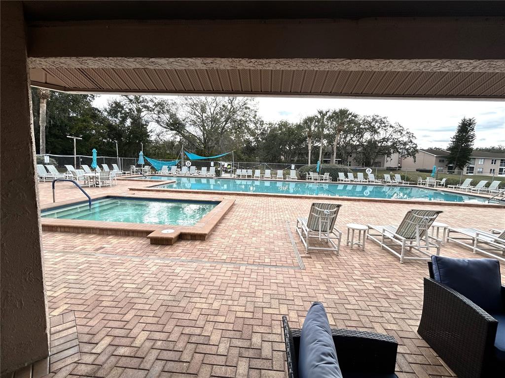 4826 Myrtle Oak Drive, Unit 23 New Port Richey, FL 34653 - Photo 31 of 42 a view of a swimming pool with a patio