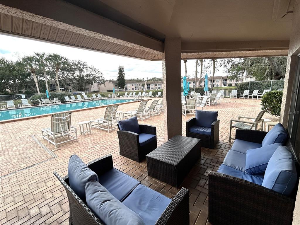 4826 Myrtle Oak Drive, Unit 23 New Port Richey, FL 34653 - Photo 32 of 42 a living room with patio furniture and a large window