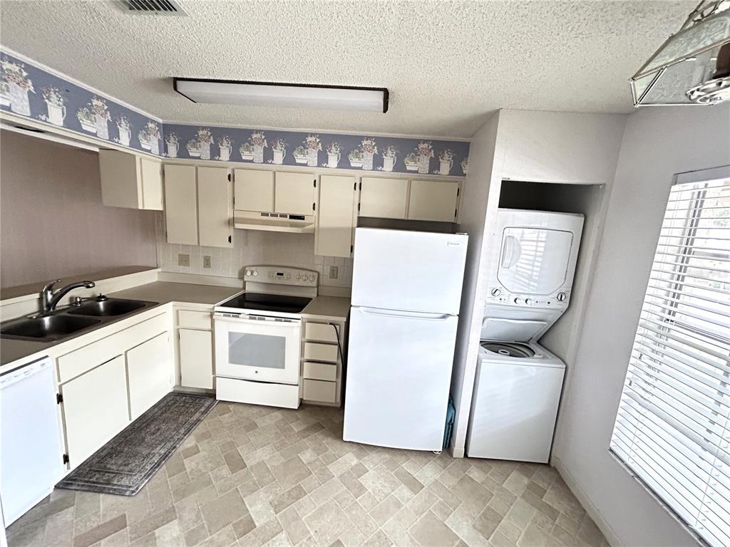 4826 Myrtle Oak Drive, Unit 23 New Port Richey, FL 34653 - Photo 7 of 42 a kitchen with a refrigerator sink stove and cabinets