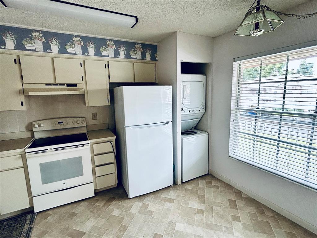 4826 Myrtle Oak Drive, Unit 23 New Port Richey, FL 34653 - Photo 8 of 42 a kitchen with a stove and a white refrigerator