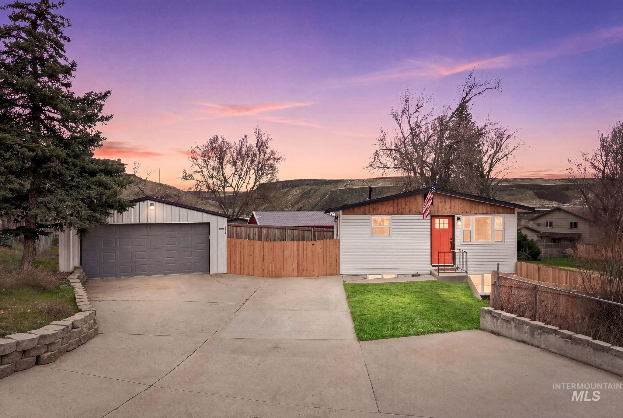 View of front facade with an outdoor structure and a detached garage