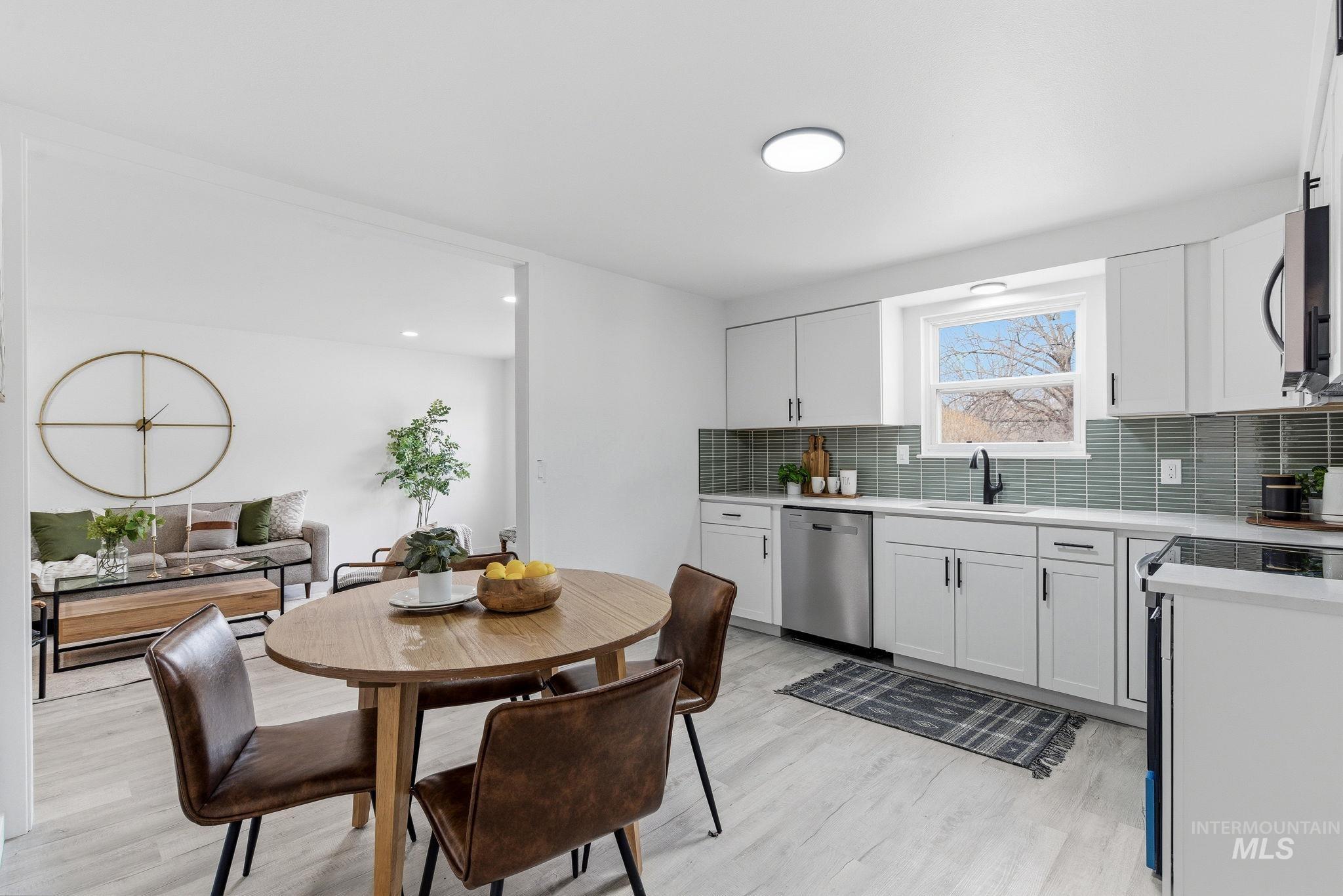 6123 South Brian Way Boise, ID 83716 - Photo 18 of 50 Kitchen with tasteful backsplash, stainless steel appliances, light wood-style flooring, white cabinetry, and recessed lighting