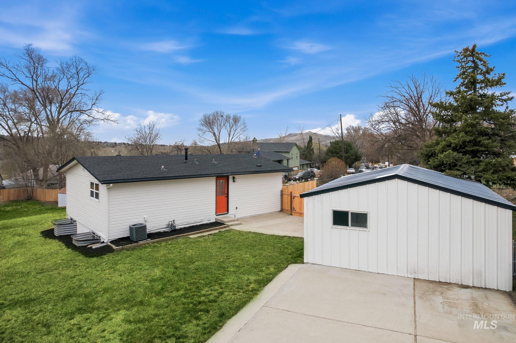 6123 South Brian Way Boise, ID 83716 - Photo 41 of 50 Rear view of house featuring a patio area, an outdoor structure, and board and batten siding
