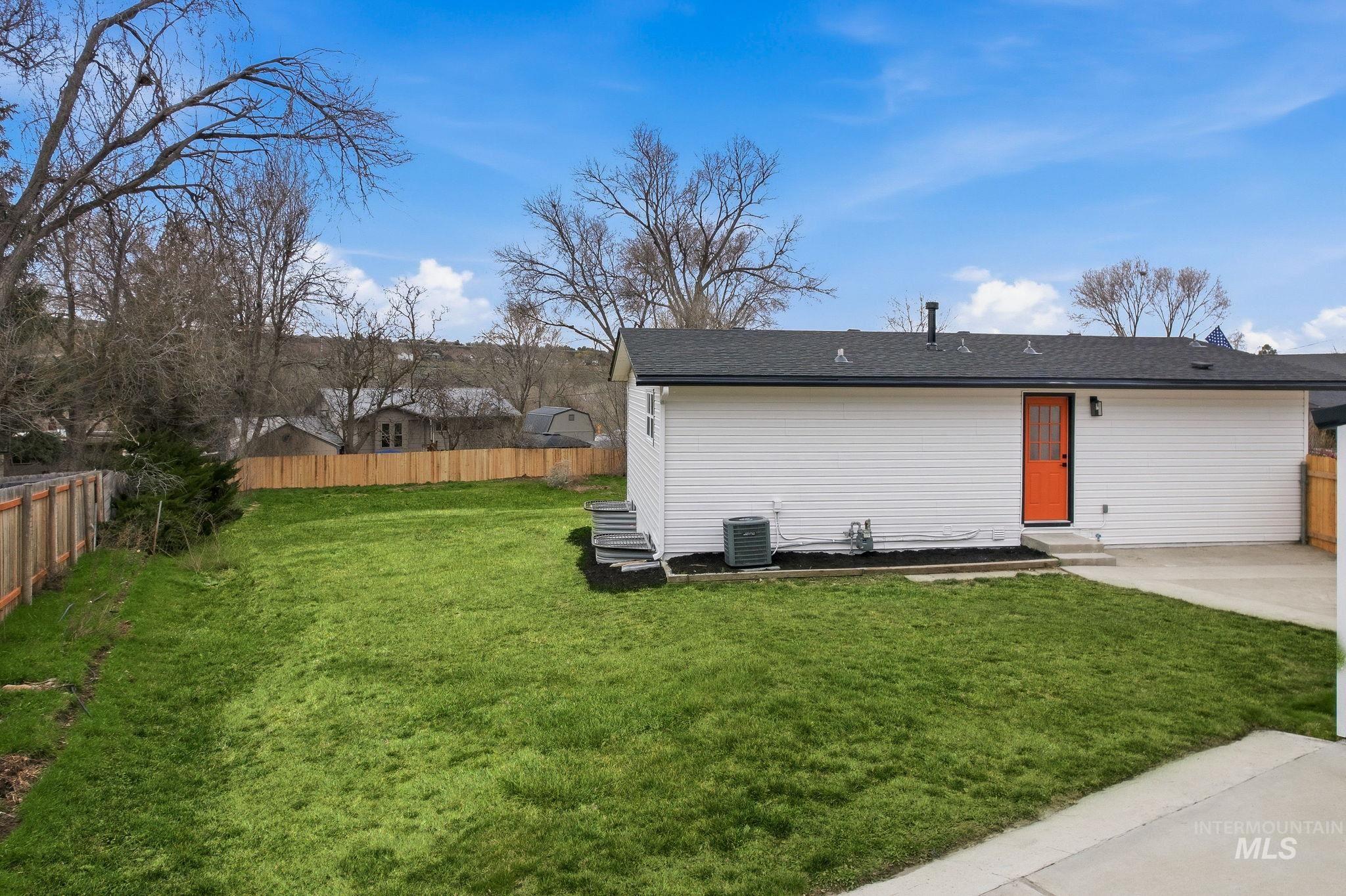 6123 South Brian Way Boise, ID 83716 - Photo 42 of 50 Back of property featuring a fenced backyard, a patio, entry steps, and a shingled roof