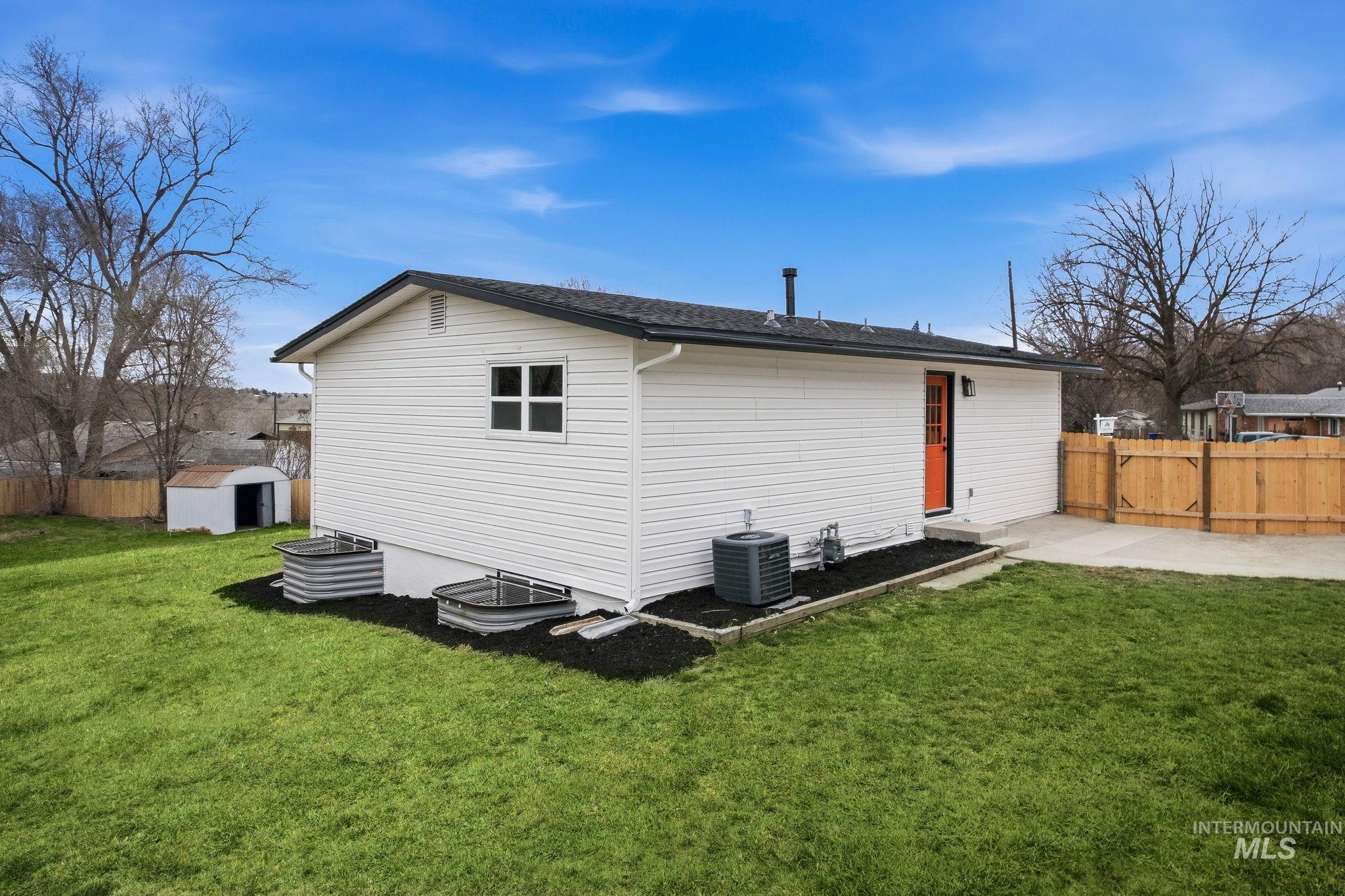 6123 South Brian Way Boise, ID 83716 - Photo 43 of 50 Back of property with a fenced backyard and an outbuilding