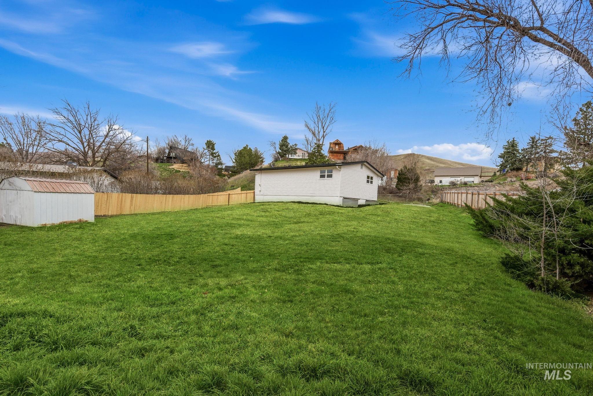 6123 South Brian Way Boise, ID 83716 - Photo 45 of 50 Fenced backyard featuring a storage unit