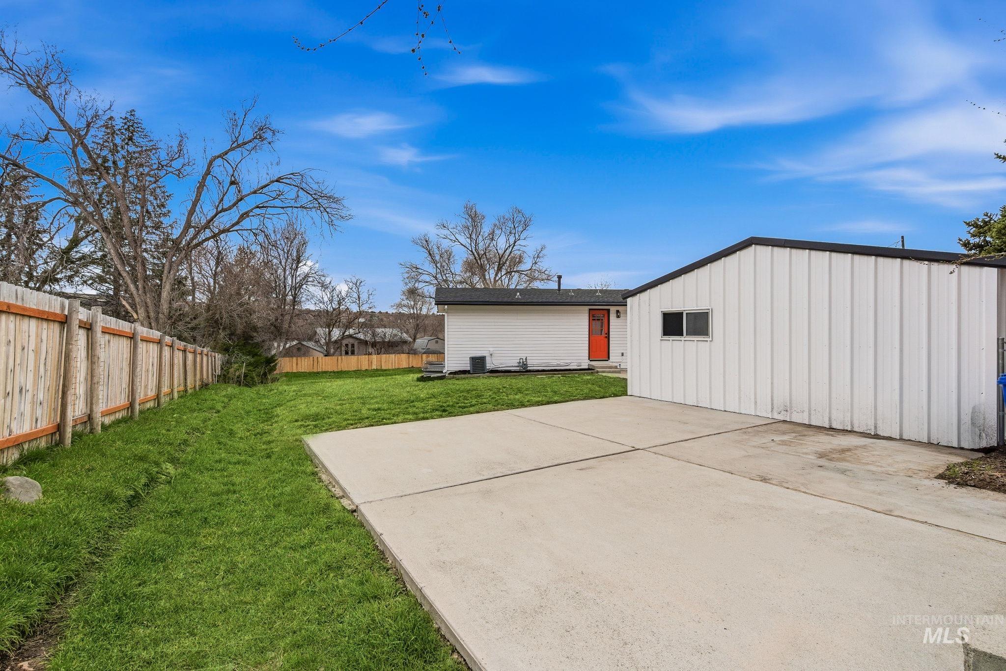 6123 South Brian Way Boise, ID 83716 - Photo 46 of 50 Rear view of property with board and batten siding, a fenced backyard, and a patio