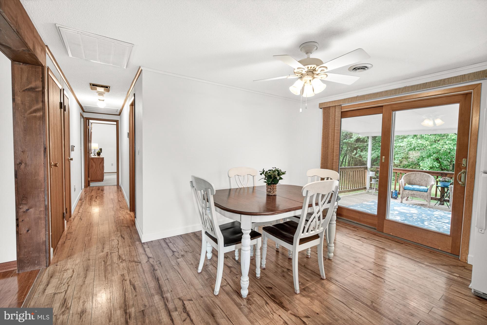 5601 Woodville Road Mount Airy, MD 21771 - Photo 11 of 54 a dining room with furniture a chandelier and wooden floor