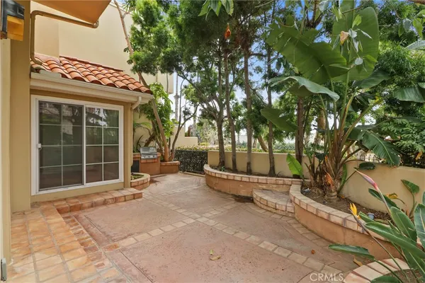 a view of a house with a large tree and a yard